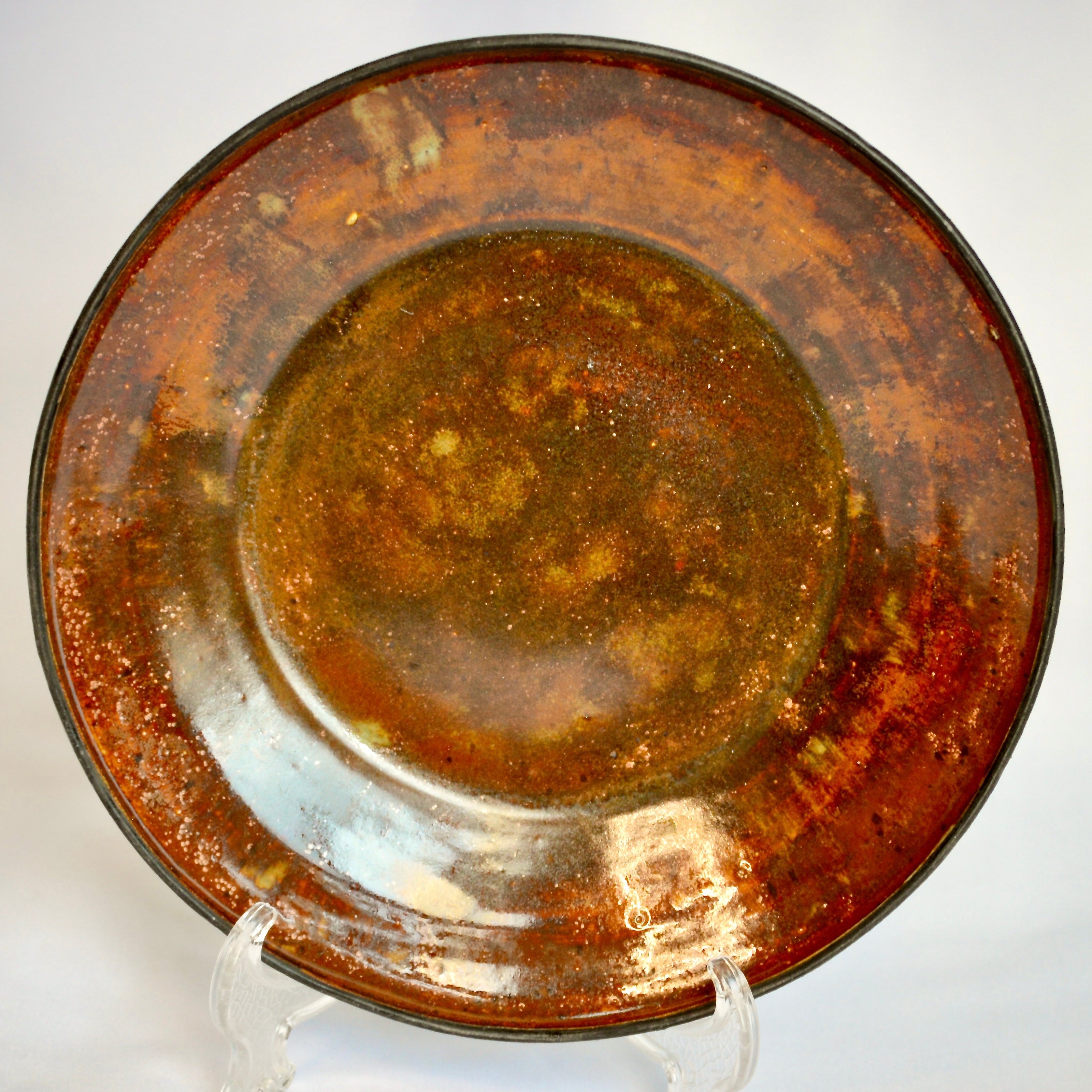 Rust-colored ceramic plate on a white background